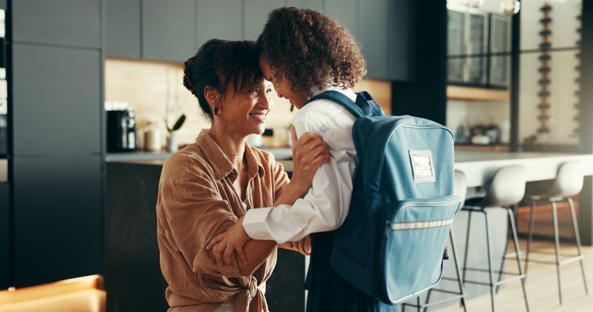 loving-mother-hugging-child-before-school-at-home back to school routine.jpg