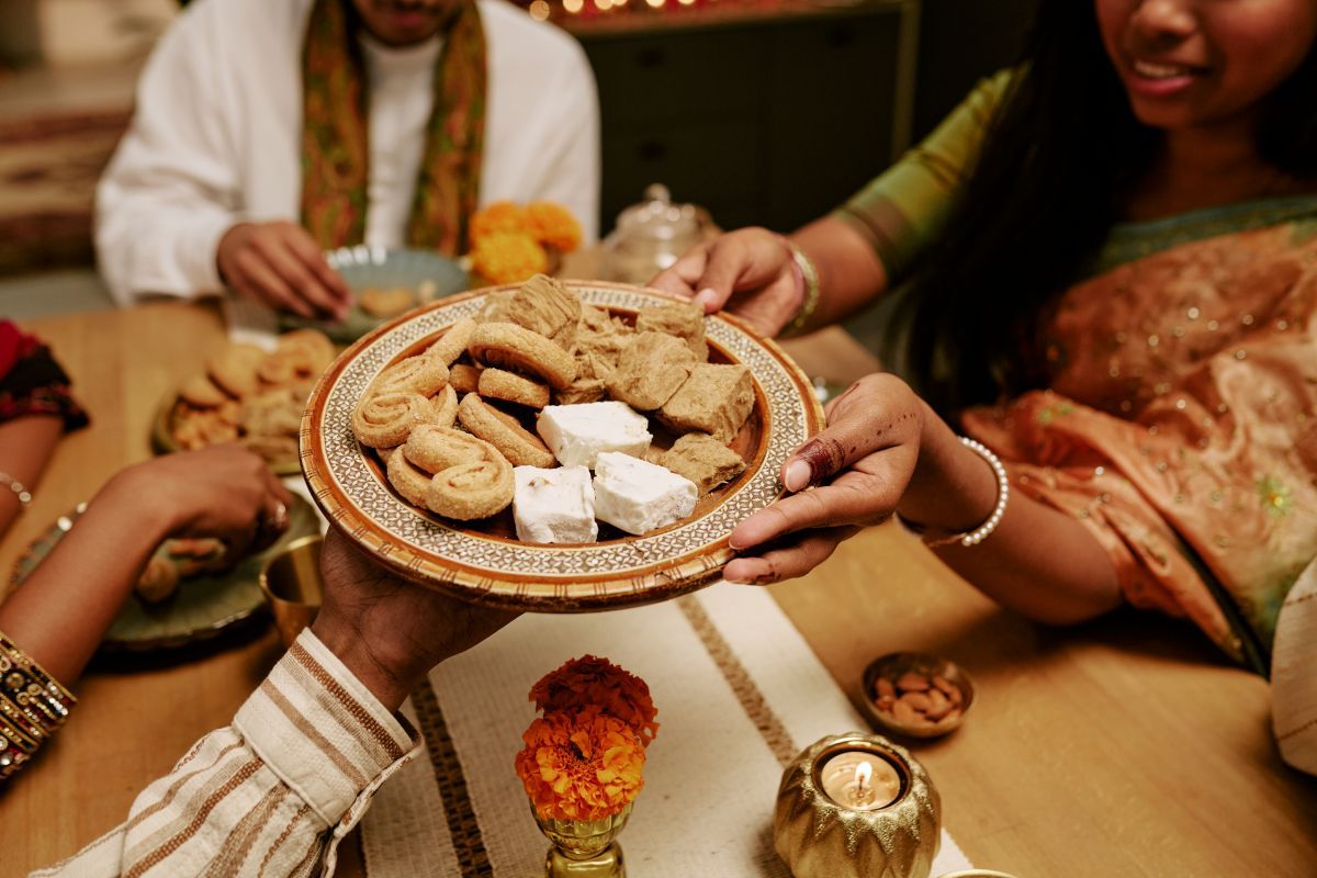 people-sharing-traditional-sweets-during-diwali.jpg